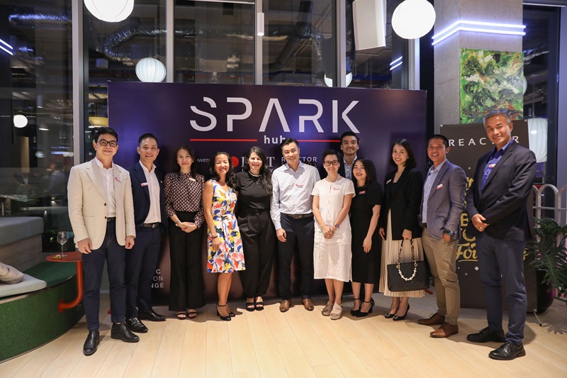 Alumni and RMIT staff pose in front of SPARK Hub backdrop